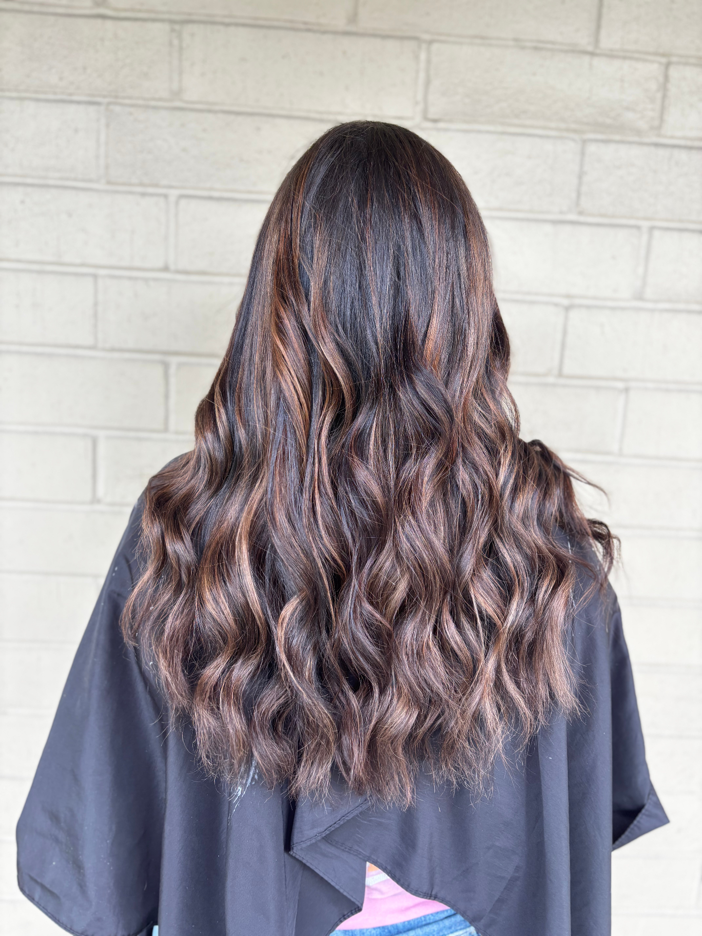 Dimensional brunette balayage with warm caramel highlights done at a Louisville Kentucky salon
