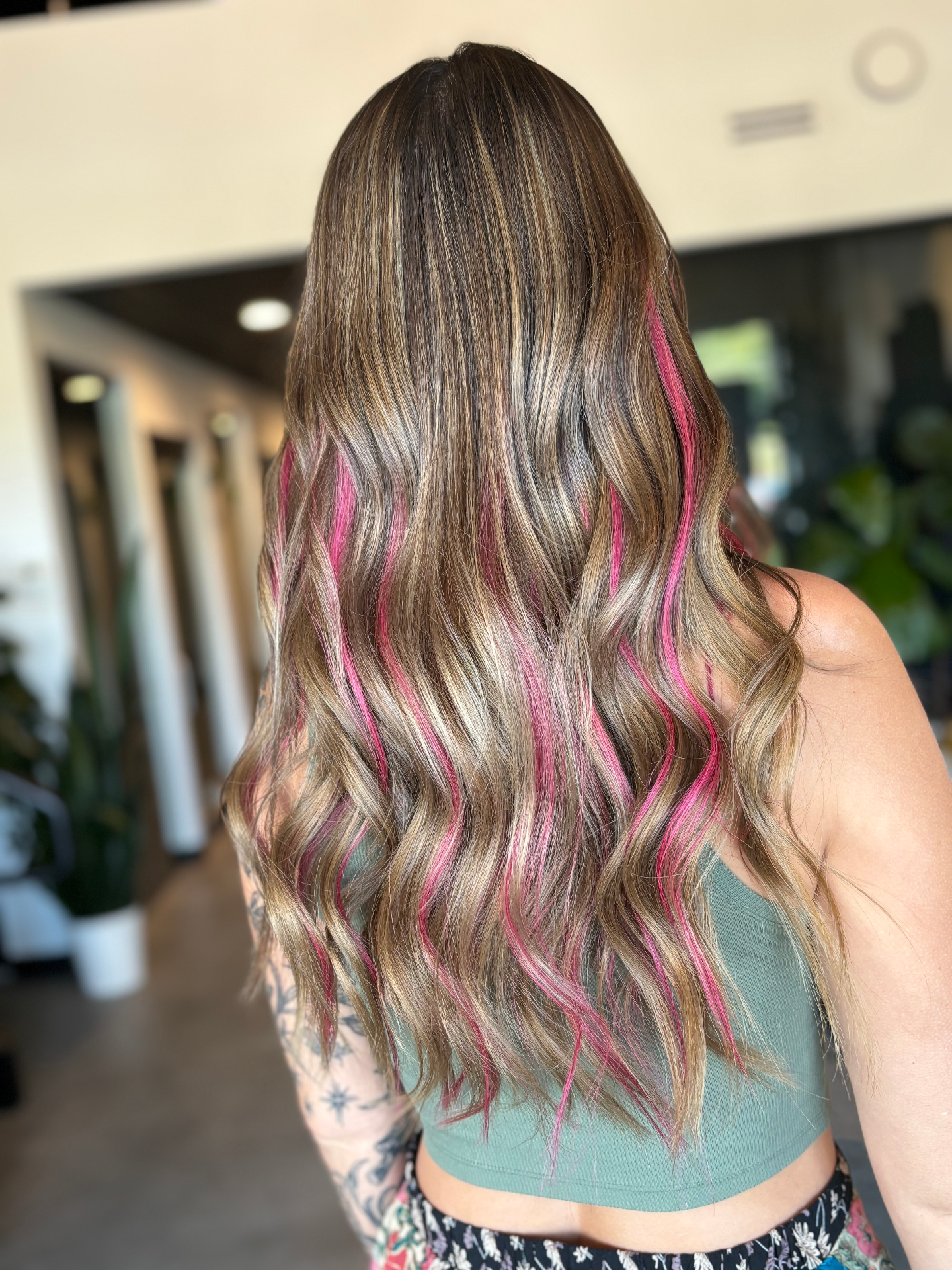 Long brunette hair with pink vivid streaks and K-tip keratin bond extensions by Katie Cheatham in Louisville, KY