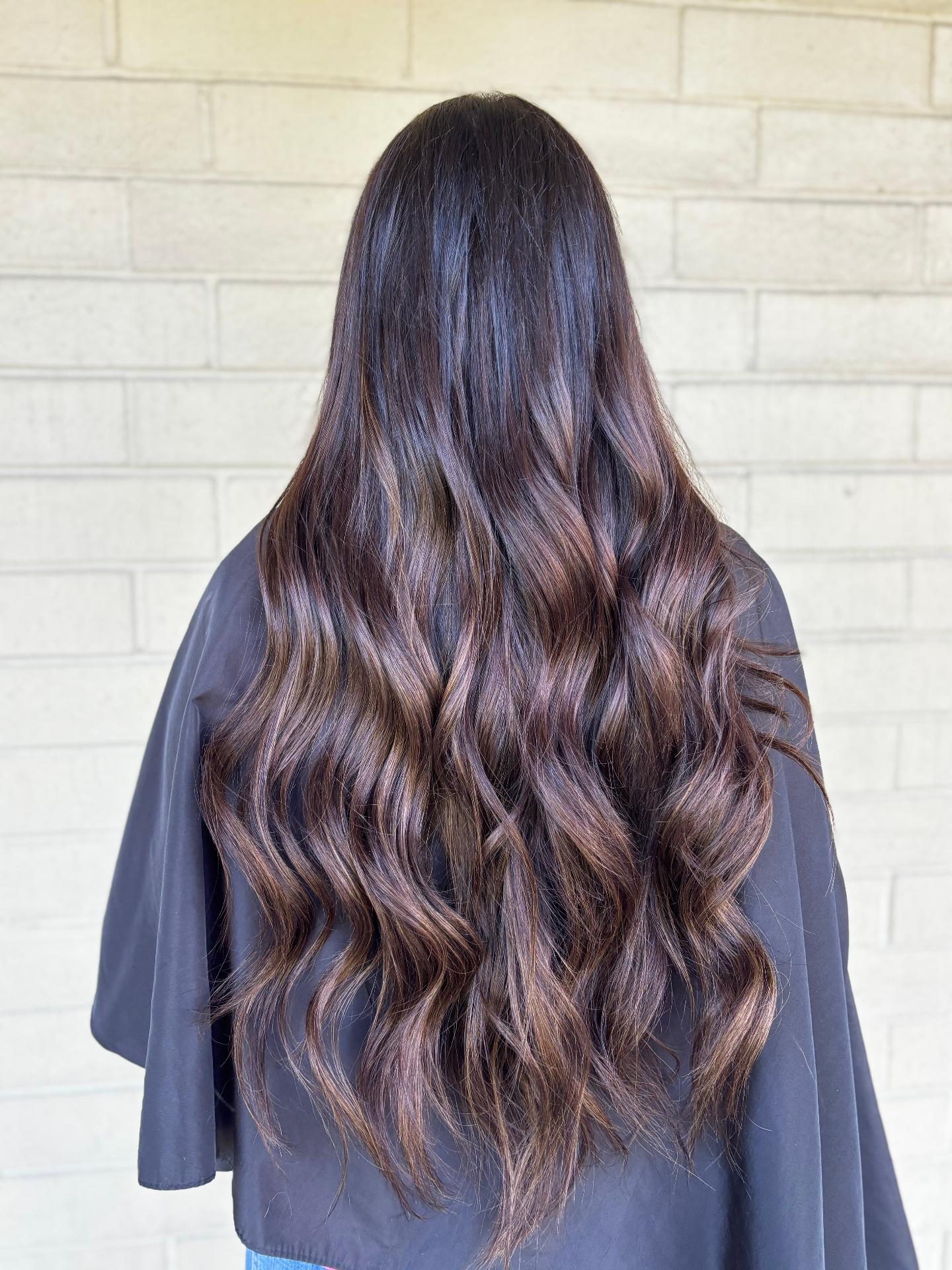 Long brunette hair with weft hair extensions showing natural dimension and length by Katie Cheatham in Louisville, KY